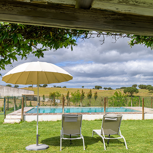 Piscina com espreguiçadeiras: Piscina exterior com espreguiçadeiras e vista para o campo, Herdade da Boavista